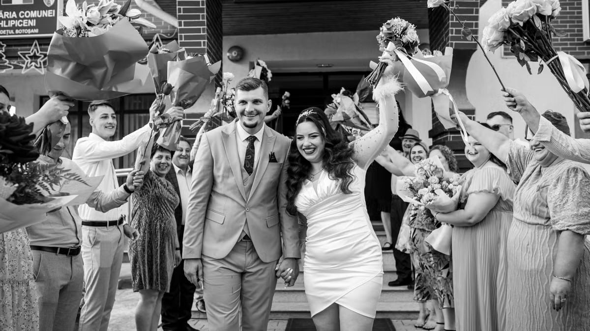 Lively outdoor wedding ceremony in Romania with happy couple and guests.